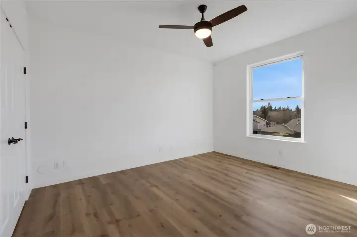 Upstairs, you'll find 3 generous bedrooms, all with remote ceiling fans, and spacious closet space.  Two of the bedrooms have new Pergo Laminate flooring installed.  This bedroom faces the front of the home.