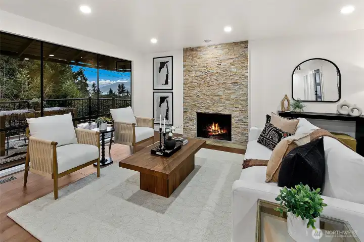 Gorgeous living room has statement fireplace and lake views!