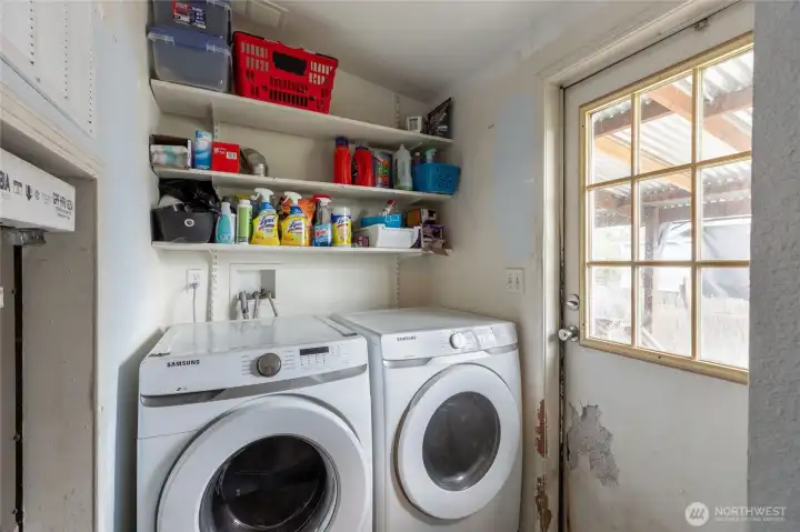 Utility room with access to porch and backyard. W/D convey with salesre.