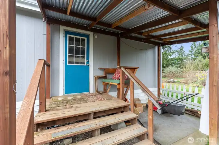 Covered back porch with access to backyard.