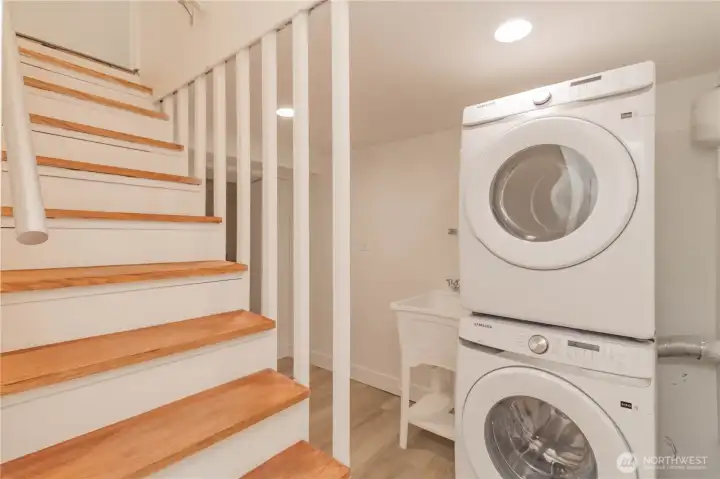 Laundry area with washer and dryer and utility sink