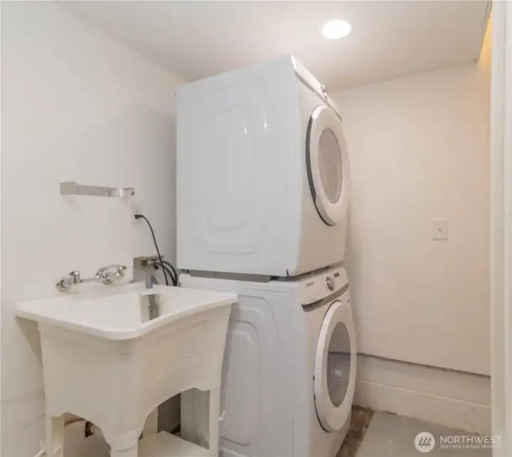 Full size stacked front loading washer and dryer with utility sink