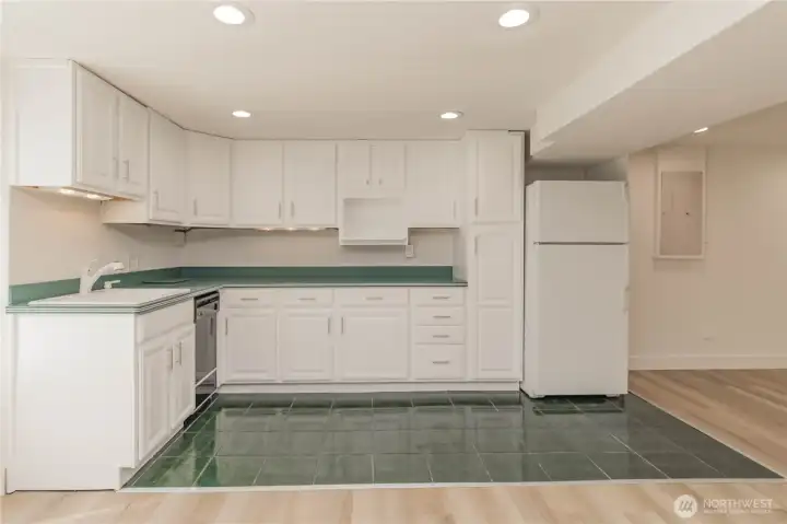 Full wet bar kitchen with fridge and refreshed cabinetry