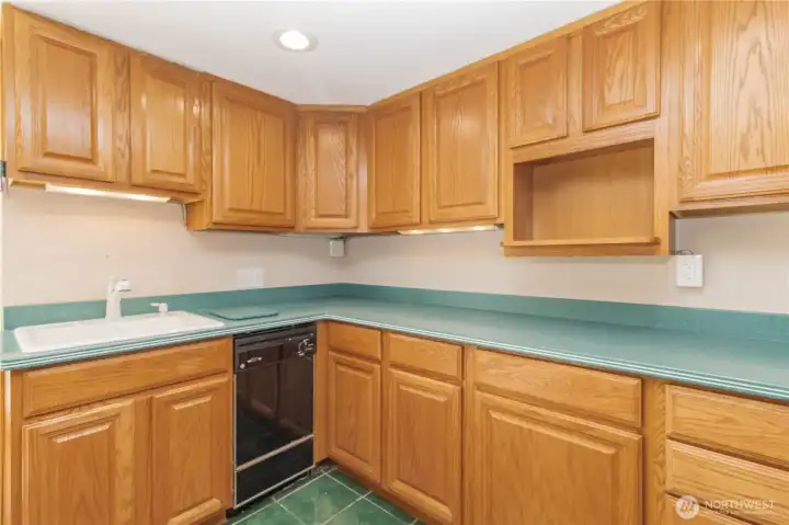 Lovely Corian counters with cabinet lighting and bonus cutting board cut-out