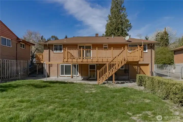 Fantastic rear view of home with large grassy area in back yard