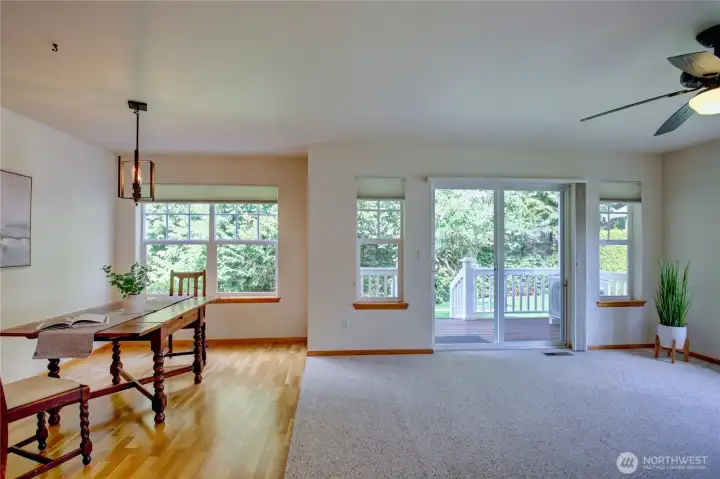 Looking from the entrance into the living room with slider to back deck, hardwood floors in dining room and kitchen.