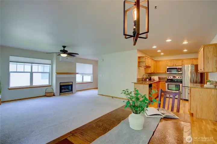 Looking from dining room into newer kitchen with granite counters, newer appliances and hardwood floors.  Gas fireplace in living room, mini-split provides air conditioning for comfort year round.