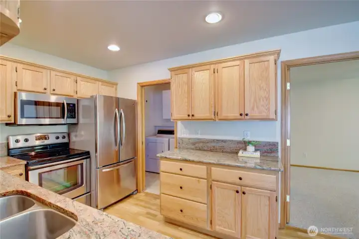 Extra cabinets and counter space, utility room on the left, primary bedroom on the right.