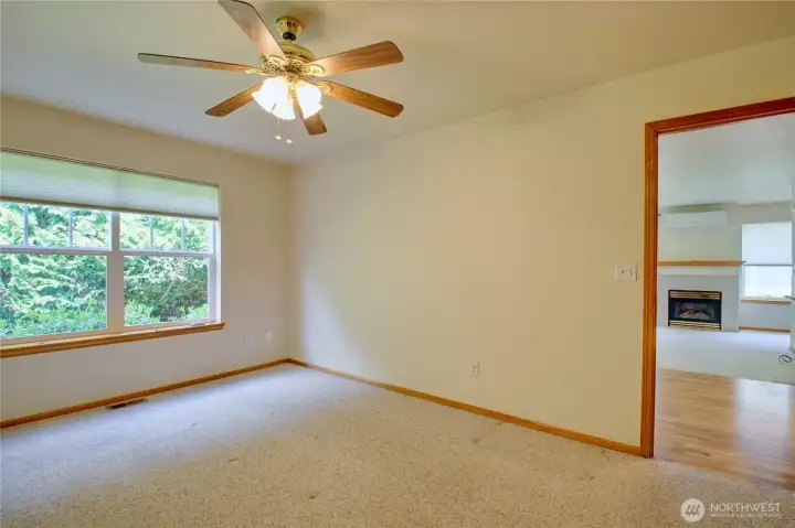 Primary bedroom with ceiling fan, nice size room.