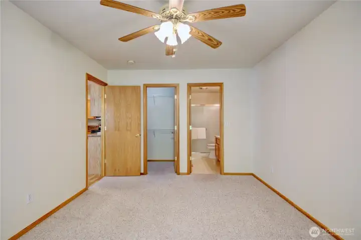 Primary bedroom with walk in closet, bathroom with walk in shower.