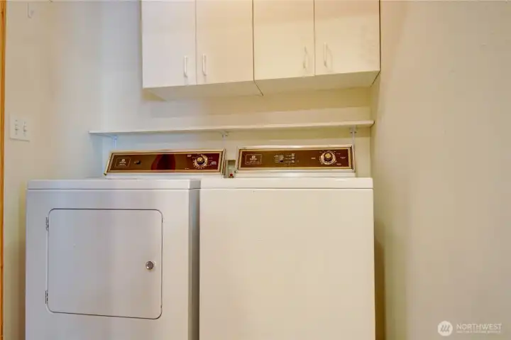 Laundry room with matching washer & dryer, extra storage and access to garage.