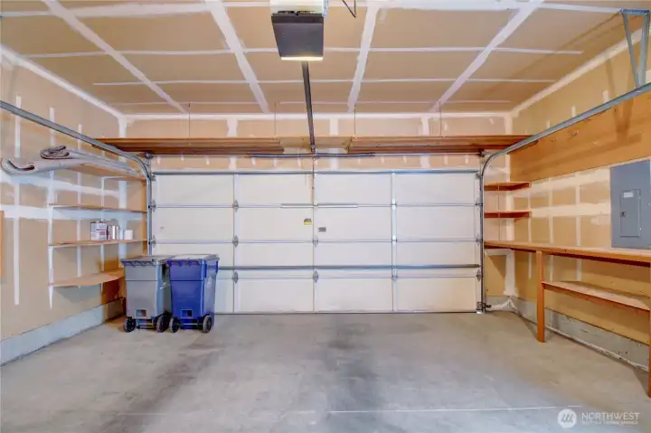 Two car garage with storage shelves.