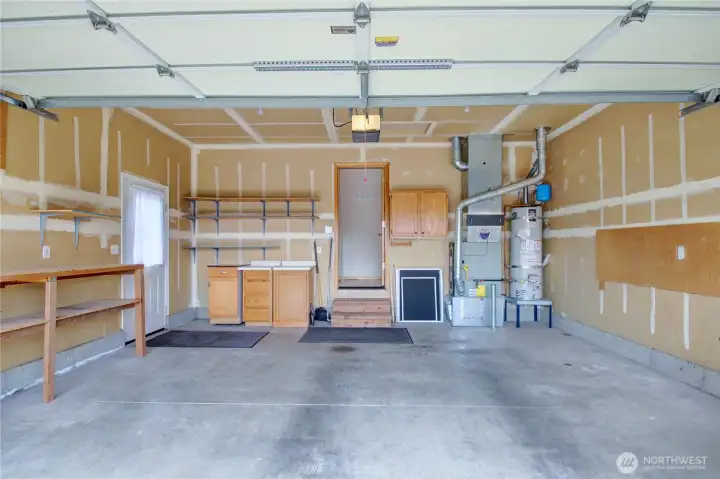 Garage with extra storage and side door.
