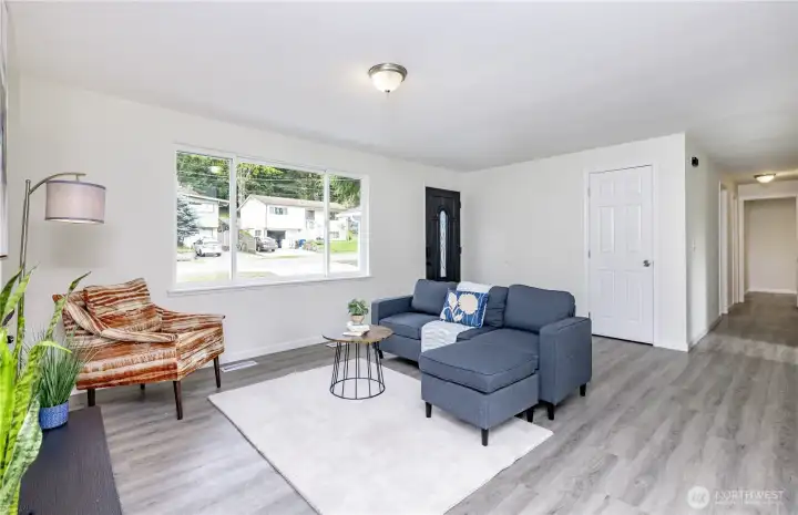 Another view of living area w/hallway & coat closet