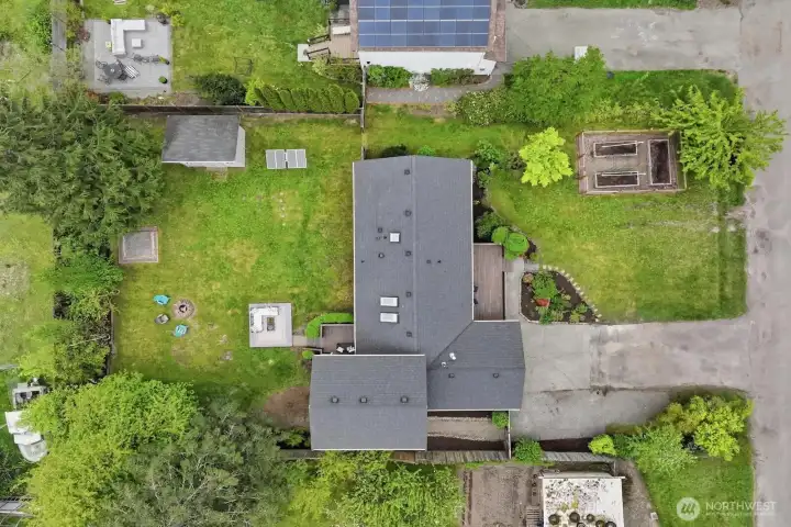 Enjoy a fully fenced, level lot with mature landscaping, dedicated garden space, a cozy fire pit, and plenty of room to roam.