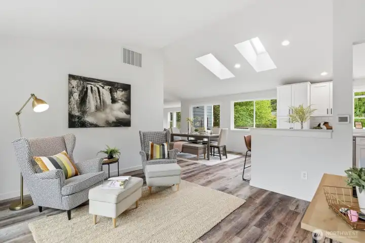 Vaulted ceilings and skylights set the tone as you enter, flowing into a bright, open-concept living space filled with beautiful natural light.