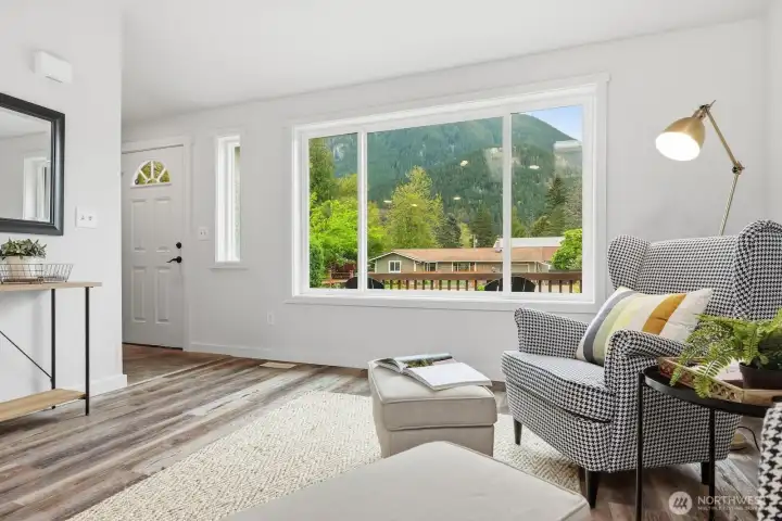 The front room greets you with a big, light-filled window that creates a bright and inviting atmosphere.