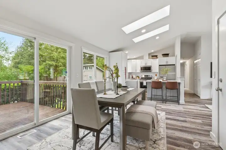 The kitchen and dining space flow effortlessly together and open through a slider to the back wraparound deck.