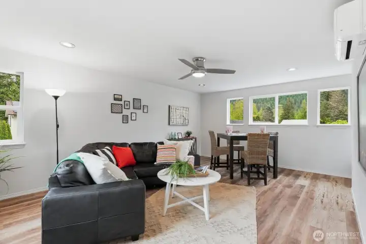Upstairs room showcases LVP flooring, newly painted interiors, a ceiling fan, and a mini-split system providing efficient A/C.