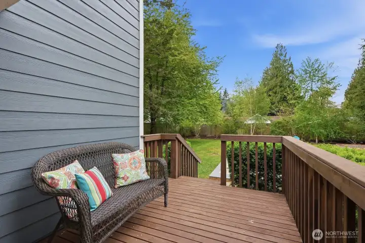 Freshly stained second deck at the rear of the home, offering an inviting outdoor extension of the living space.