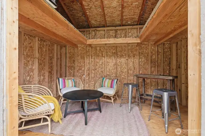 Inside the outbuilding is a large, versatile space with a loft—perfect for a workshop, extra storage, or inspiring creative projects.