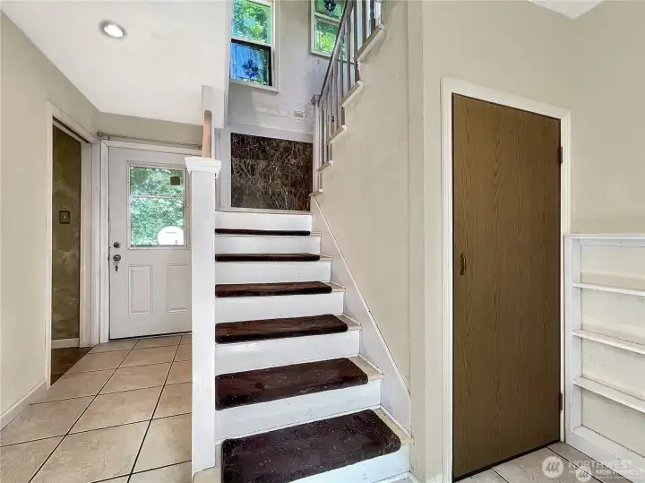 Full view of back door. half bath on left and closet on right Full view of back door. half bath on left and closet on right