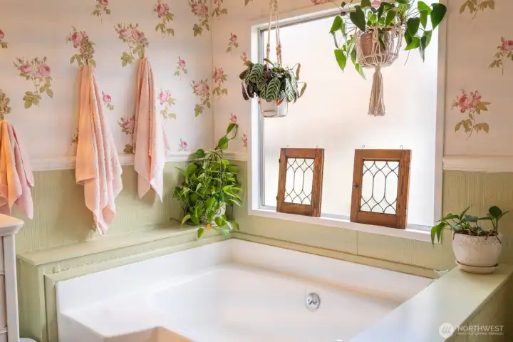 Primary bathroom with soaking tub and frosted window for privacy. Primary bathroom with soaking tub and frosted window for privacy.
