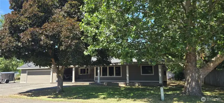 Front of home with large shade trees