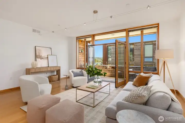 The great room’s wall of floor-to-ceiling windows and doors creates a bright and cheerful atmosphere. The great room’s wall of floor-to-ceiling windows and doors creates a bright and cheerful atmosphere.