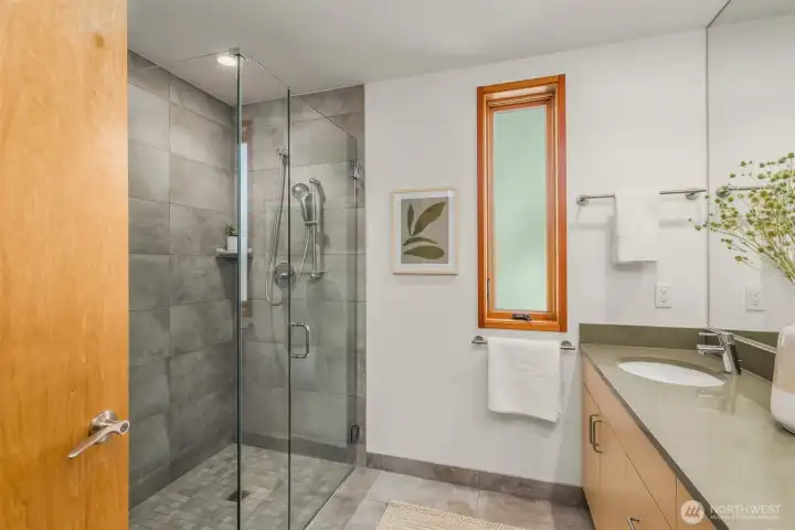 The primary bathroom also offers a zero-clearance tiled shower, in exceptional, like-new condition. The primary bathroom also offers a zero-clearance tiled shower, in exceptional, like-new condition.