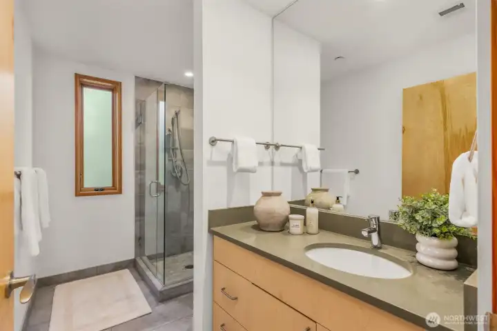 The guest bath, just off the great room, includes the same quality finishes seen in the kitchen and primary bath. The consistency of the materials creates a harmonious home. The guest bath, just off the great room, includes the same quality finishes seen in the kitchen and primary bath. The consistency of the materials creates a harmonious home.