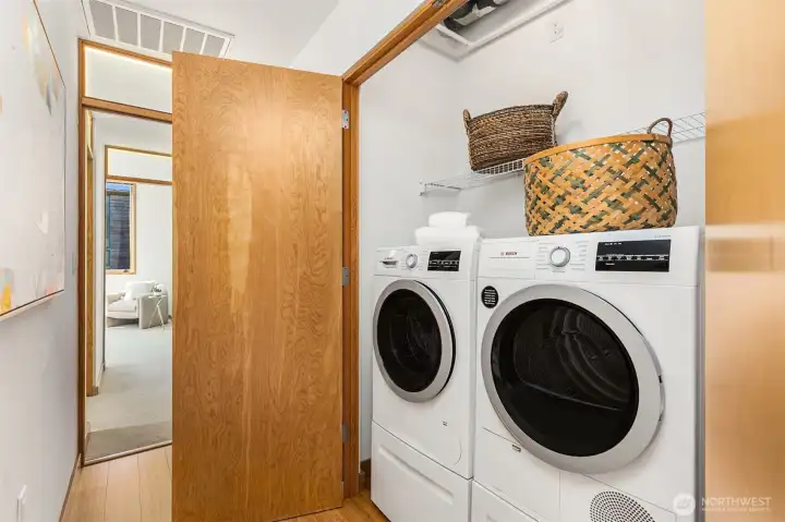 The efficient laundry houses quality Bosch washer and dryer on pedestals. The tall ceiling creates ample storage space above. Here, you will also see the inner workings of the home’s high tech ventilation system, which includes HEPA filtration and heat recovery ventilation to maintain excellent indoor air quality and save on heating bills (though the unit’s ducted heat pump already provides very affordable central heating and cooling). The efficient laundry houses quality Bosch washer and dryer on pedestals. The tall ceiling creates ample storage space above. Here, you will also see the inner workings of the home’s high tech ventilation system, which includes HEPA filtration and heat recovery ventilation to maintain excellent indoor air quality and save on heating bills (though the unit’s ducted heat pump already provides very affordable central heating and cooling).