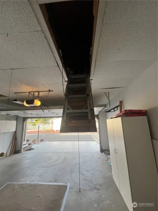 Second pull down storage ladder with extra storage in garage attic.