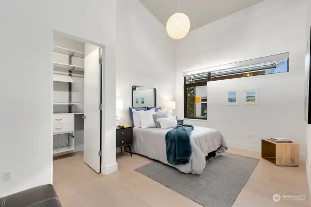 Guest bedroom with walk-in closet and super high ceilings. Could build an in-house treehouse up there!