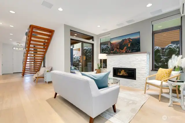 Family room centered around a marble gas fireplace; access to the outdoor covered patio