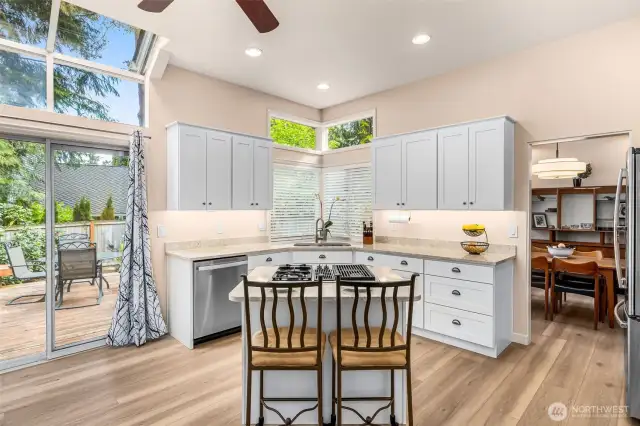Kitchen island has gas burners and additional eating space
