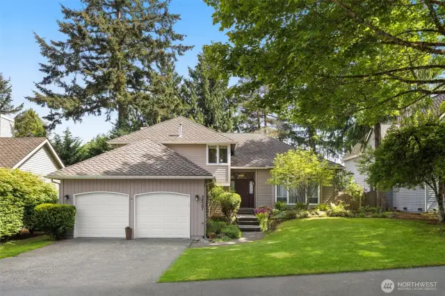 Beautifully landscaped and even has newer garage doors.