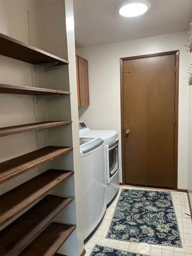 laundry area with shelving to keep shoes etc