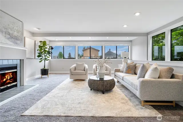 Upper floor: Sun-filled living space featuring a cozy fireplace