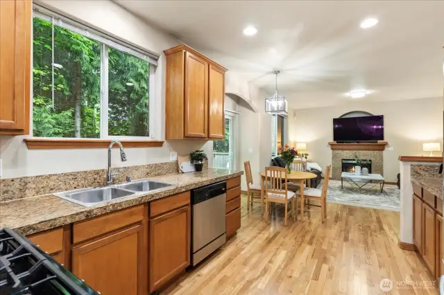 Into the kitchen: granite counters, tons of cabinetry, open concept.