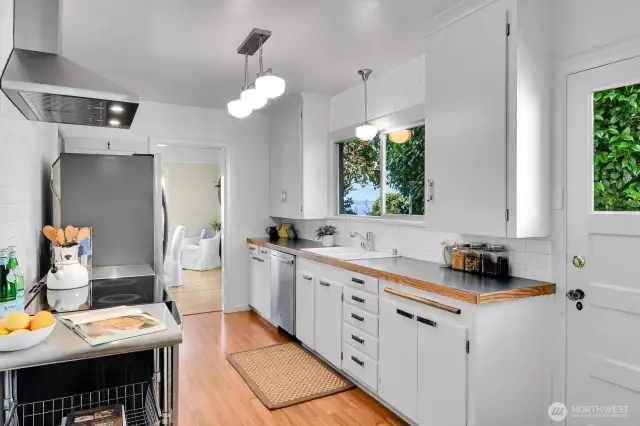 Galley kitchen with peek views, new paint, tile, lighting & appliances.