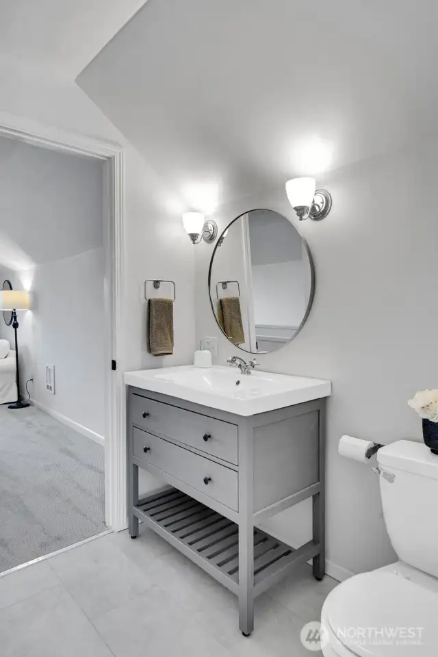 New vanity, sconce lighting & flooring in the primary suite 3/4 bath. Expand the shower & you will have it all!