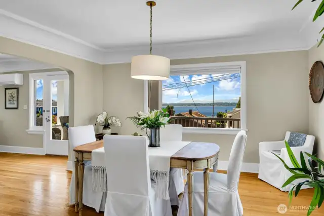 Classic dining room filled with light. Custom window coverings & air conditioning.