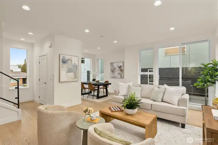 Flexible lounge and dining zone with room for a large table or sectional. Neutral finishes make styling effortless.