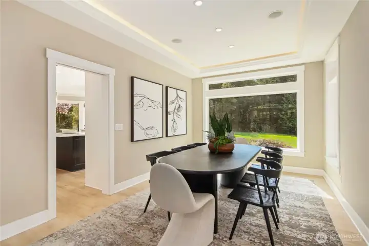 Light-filled dining room featuring elegant lighting, a spacious layout—perfect for entertaining.