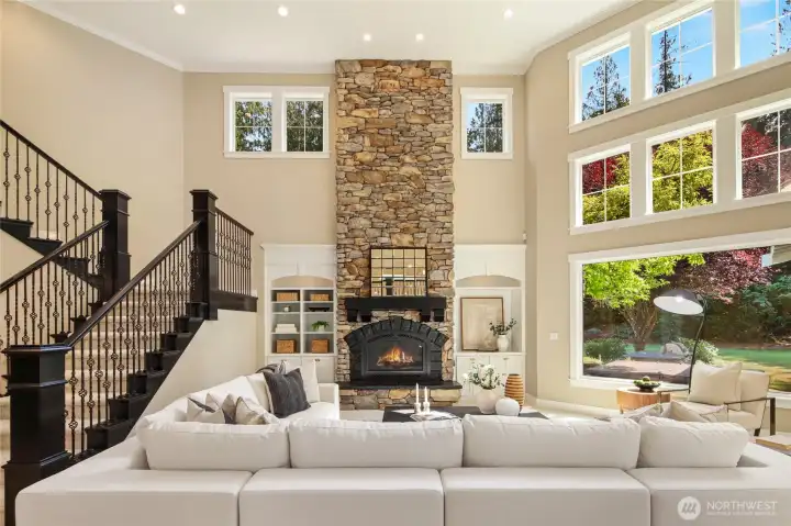 Elegant great room with stone fireplace, custom details, and soaring ceilings.