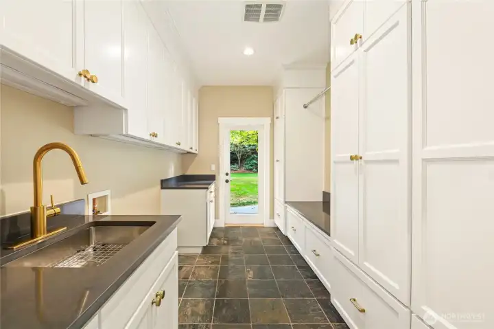 Spacious laundry-mudroom room w/ new cabinetry  & direct access to backyard jacuzzi.