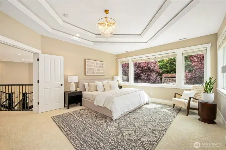 Luxurious primary suite w/ fireplace & spa-like ensuite featuring heated floors, freestanding tub, dual vanities & walk-in shower.