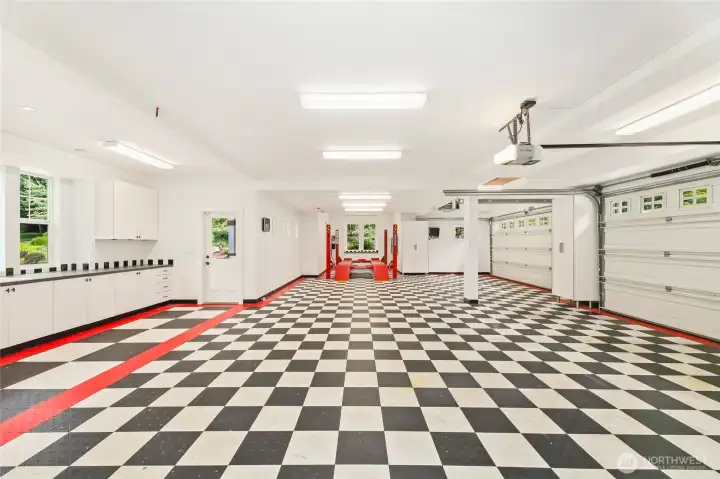 Oversized 5-car garage features abundant built-in storage and a heavy-duty 4-post lift rated to 9,000 lbs—ideal for auto enthusiasts