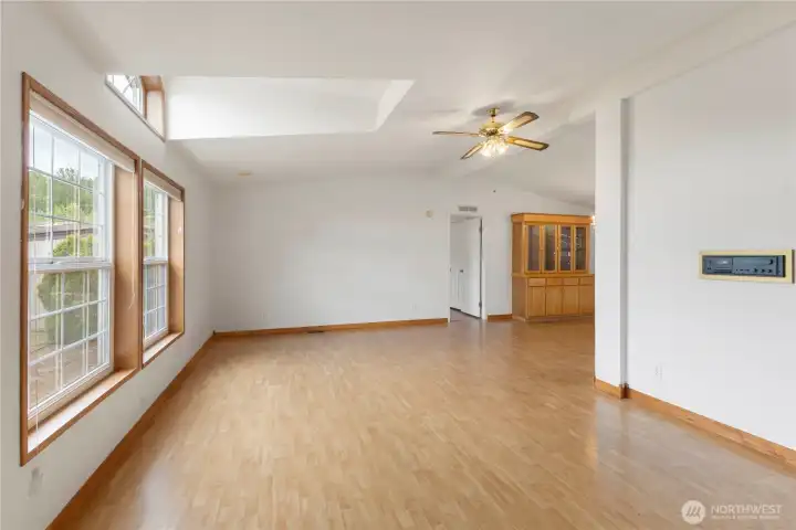 Bright living room featuring laminate flooring across the main spaces